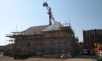 Work takes place on apartment roofing